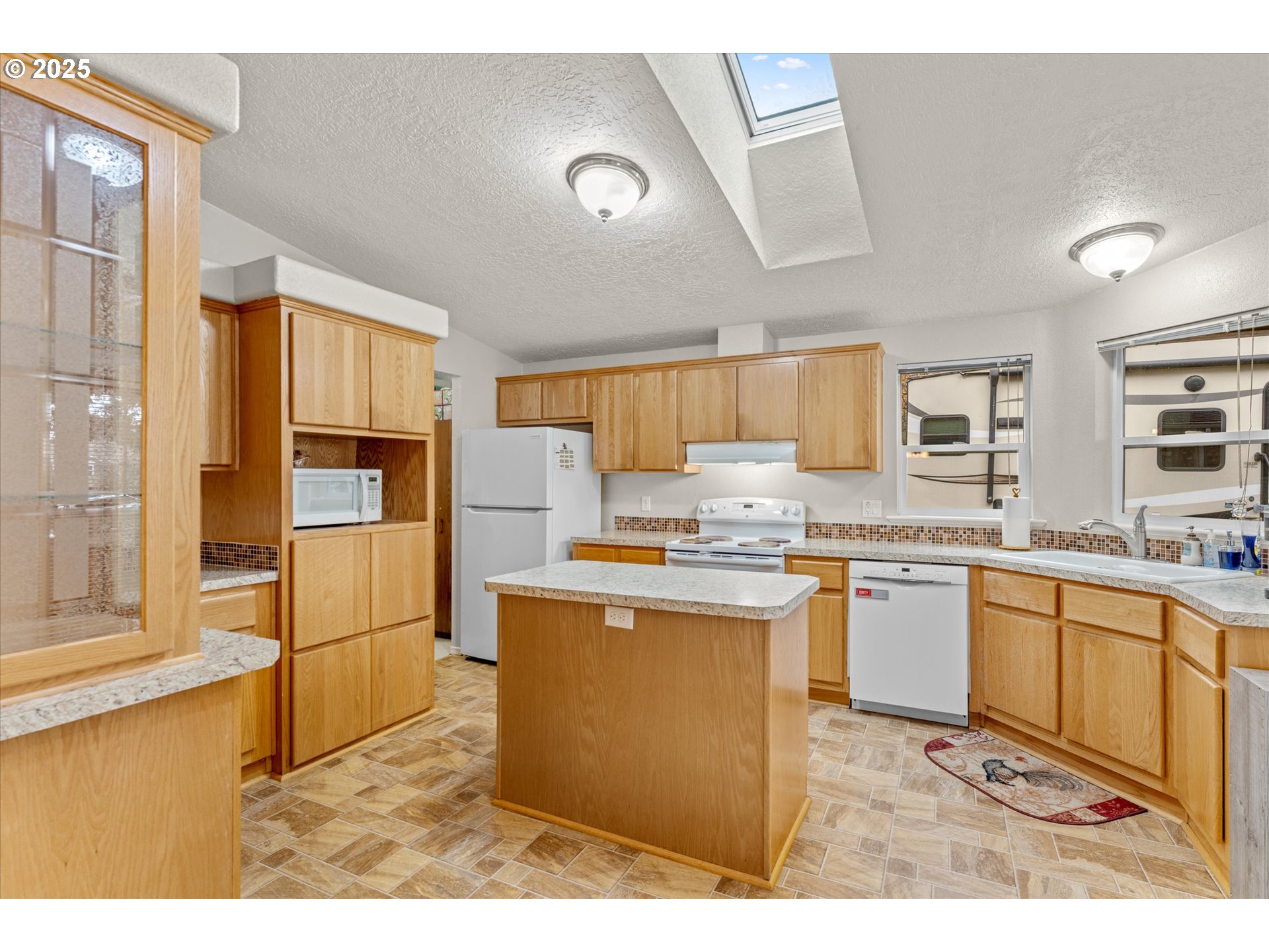 29010 Northeast 63rd Circle Camas, WA 98607 - Photo 7 of 30 a kitchen with stainless steel appliances granite countertop a stove a sink dishwasher and a refrigerator