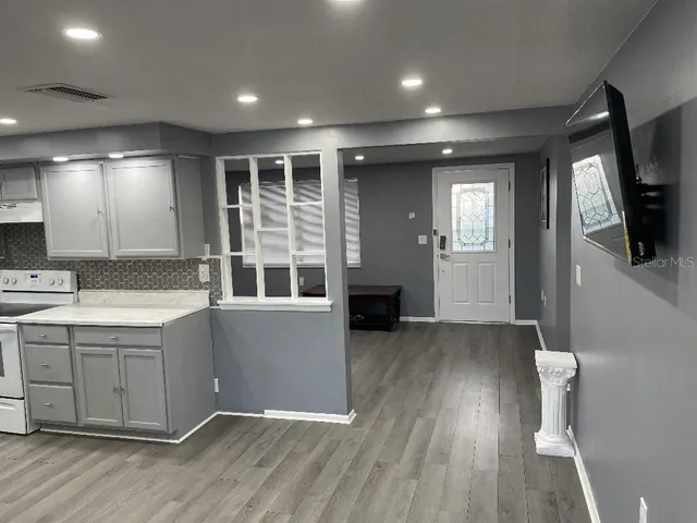 a view of kitchen with sink and wooden floor