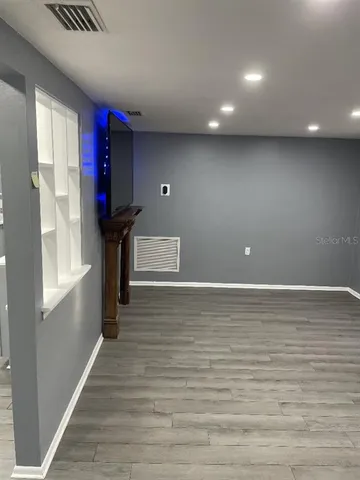 a view of room with window and wooden floor