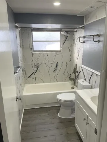 a bathroom with a sink a toilet and a bathtub