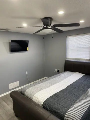 a bedroom with a bed and a flat screen tv