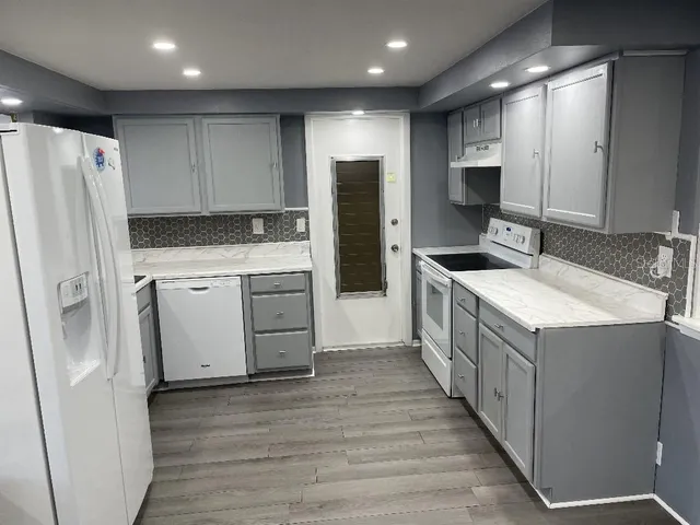 a kitchen with stainless steel appliances a sink and a refrigerator
