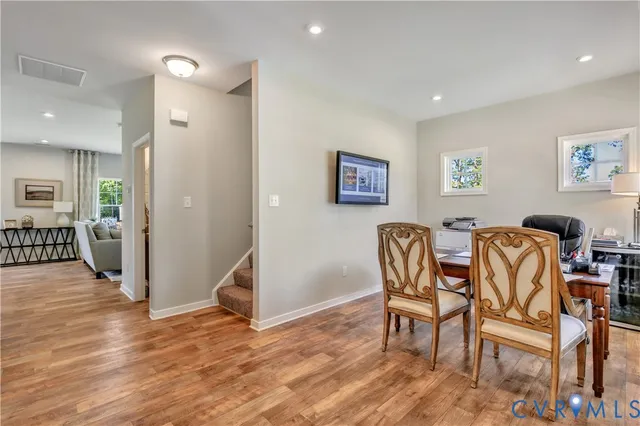 a view of a dining room with furniture and wooden floor