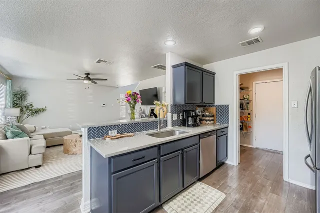 a kitchen with a sink and cabinets