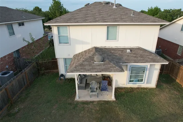a backyard of a house with table and chairs