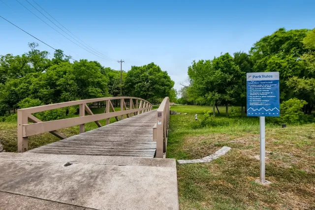 a view of a park with large trees