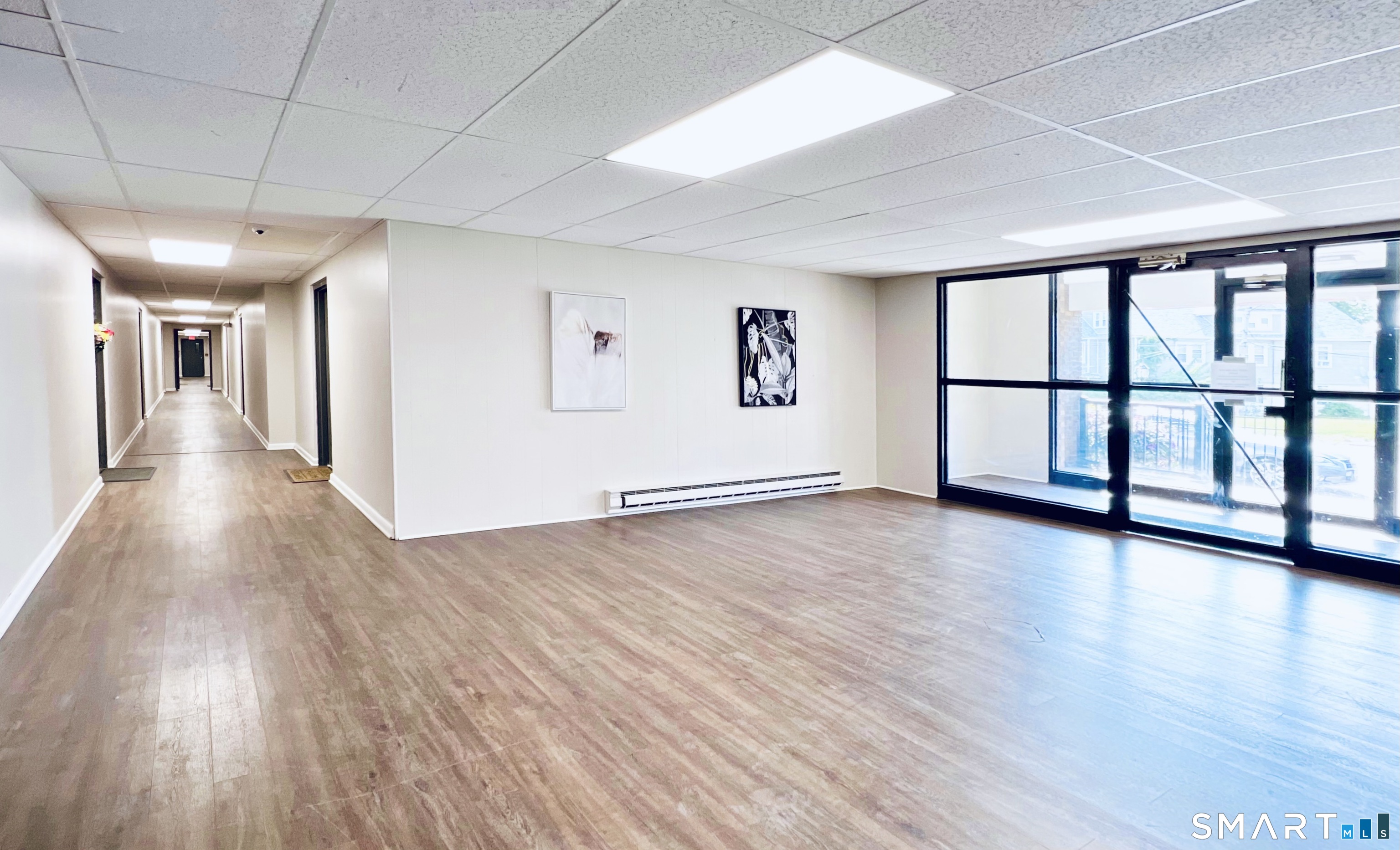 45 Monroe Street, Unit B14 Bridgeport, CT 06605 - Photo 3 of 3 a view of a big room with wooden floor and windows