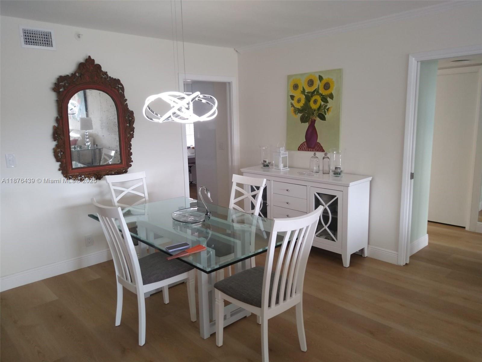 3510 Oaks Way, Unit 509 Pompano Beach, FL 33069 - Photo 12 of 36 a view of a dining room with furniture and wooden floor