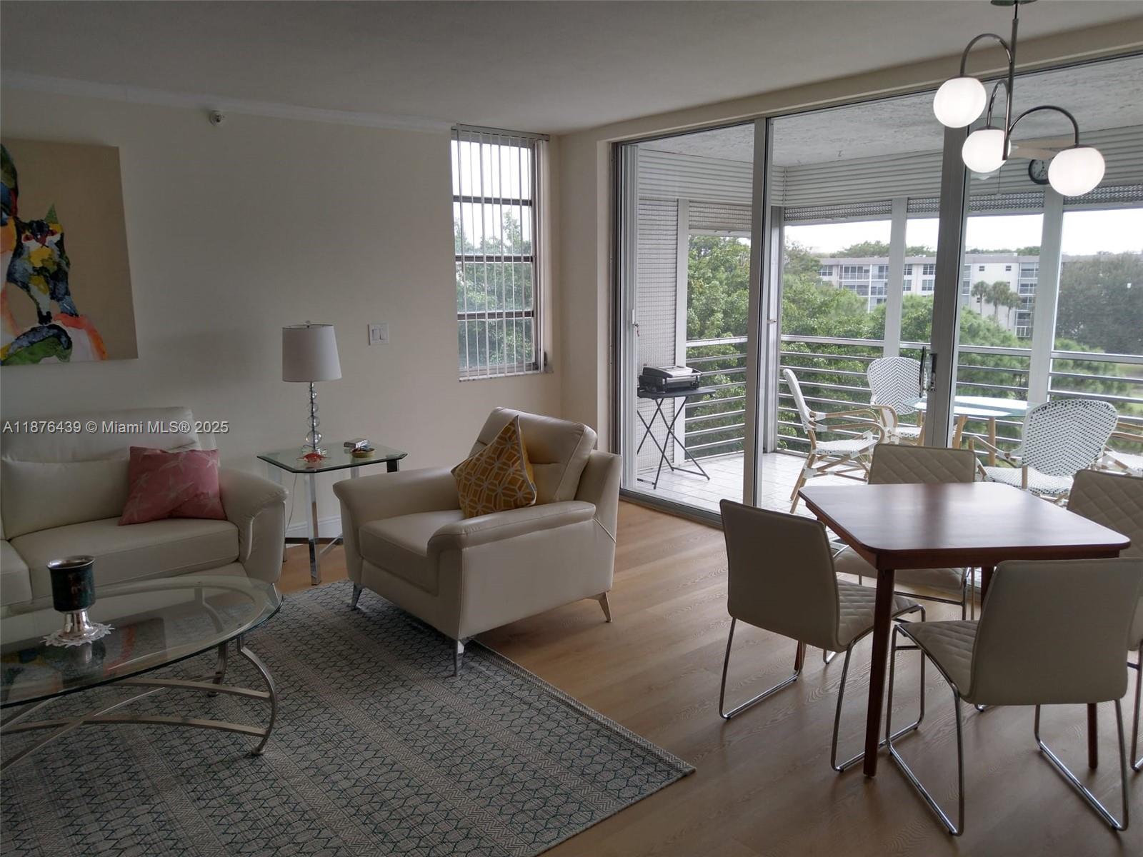 3510 Oaks Way, Unit 509 Pompano Beach, FL 33069 - Photo 13 of 36 a living room with furniture and a large window