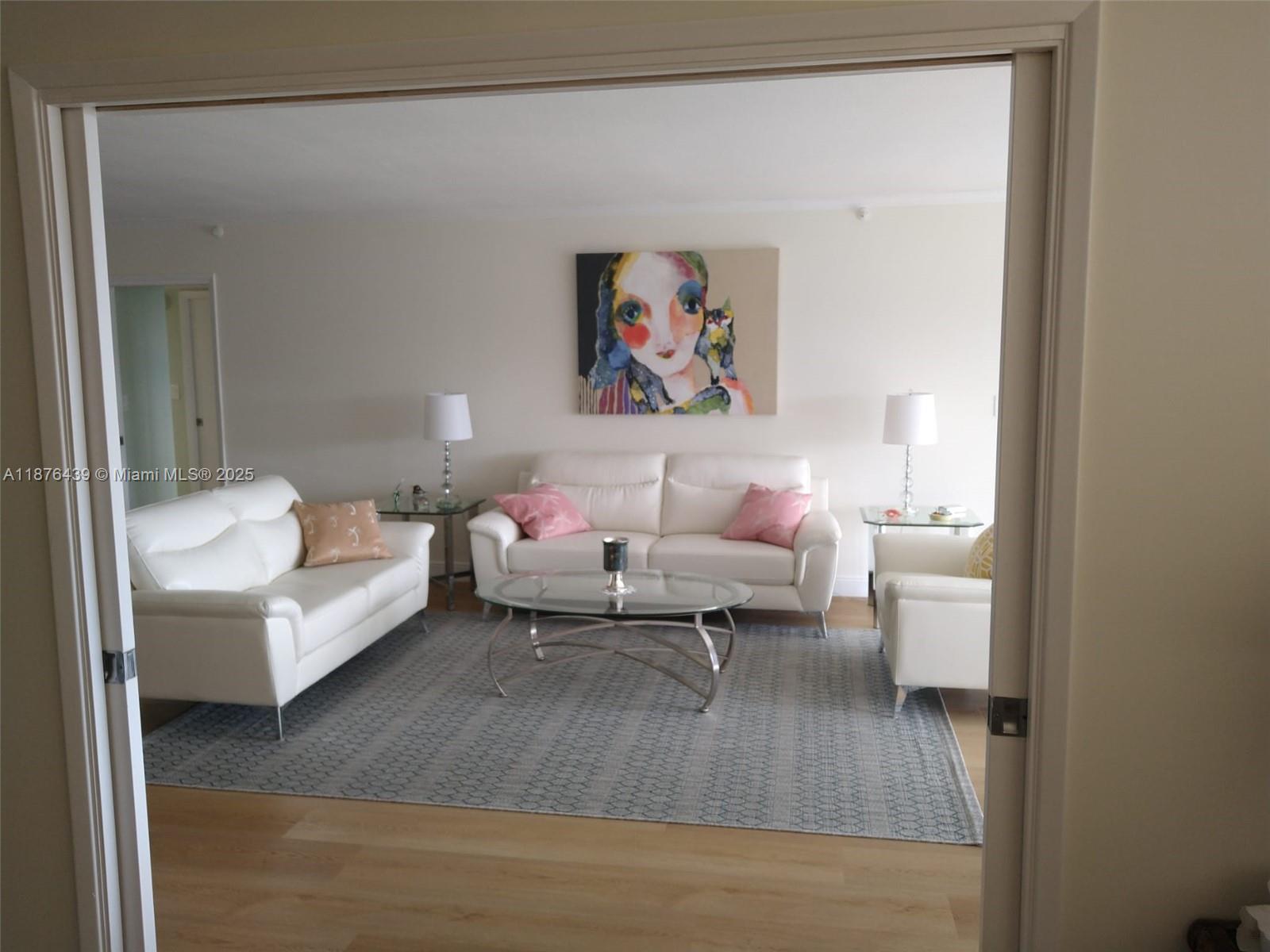 3510 Oaks Way, Unit 509 Pompano Beach, FL 33069 - Photo 15 of 36 a living room with furniture and a wooden floor