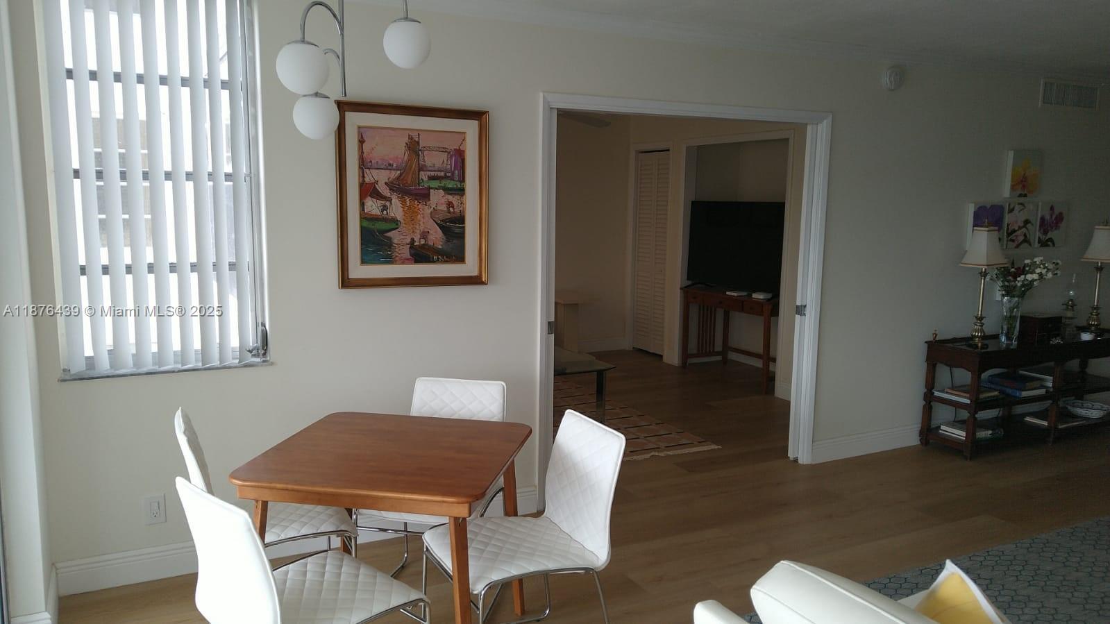 3510 Oaks Way, Unit 509 Pompano Beach, FL 33069 - Photo 23 of 36 a view of a dining room with furniture window and wooden floor