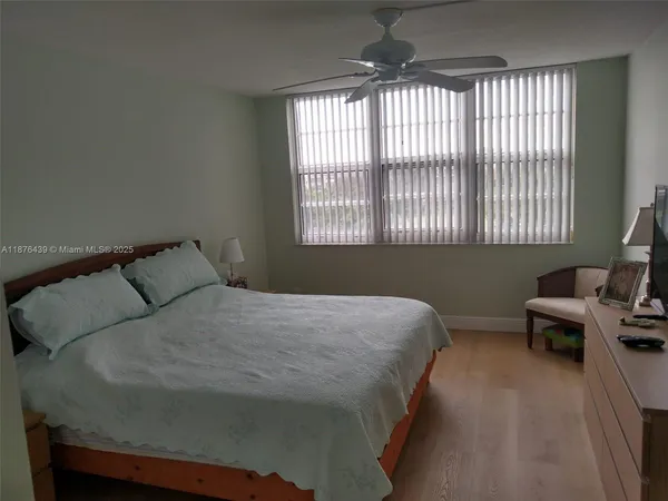 a large bed sitting in a bedroom next to a window