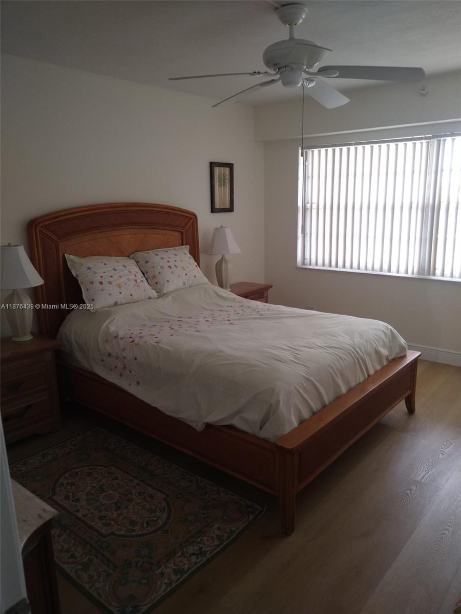 3510 Oaks Way, Unit 509 Pompano Beach, FL 33069 - Photo 26 of 36 a large bed sitting in a bedroom next to a window