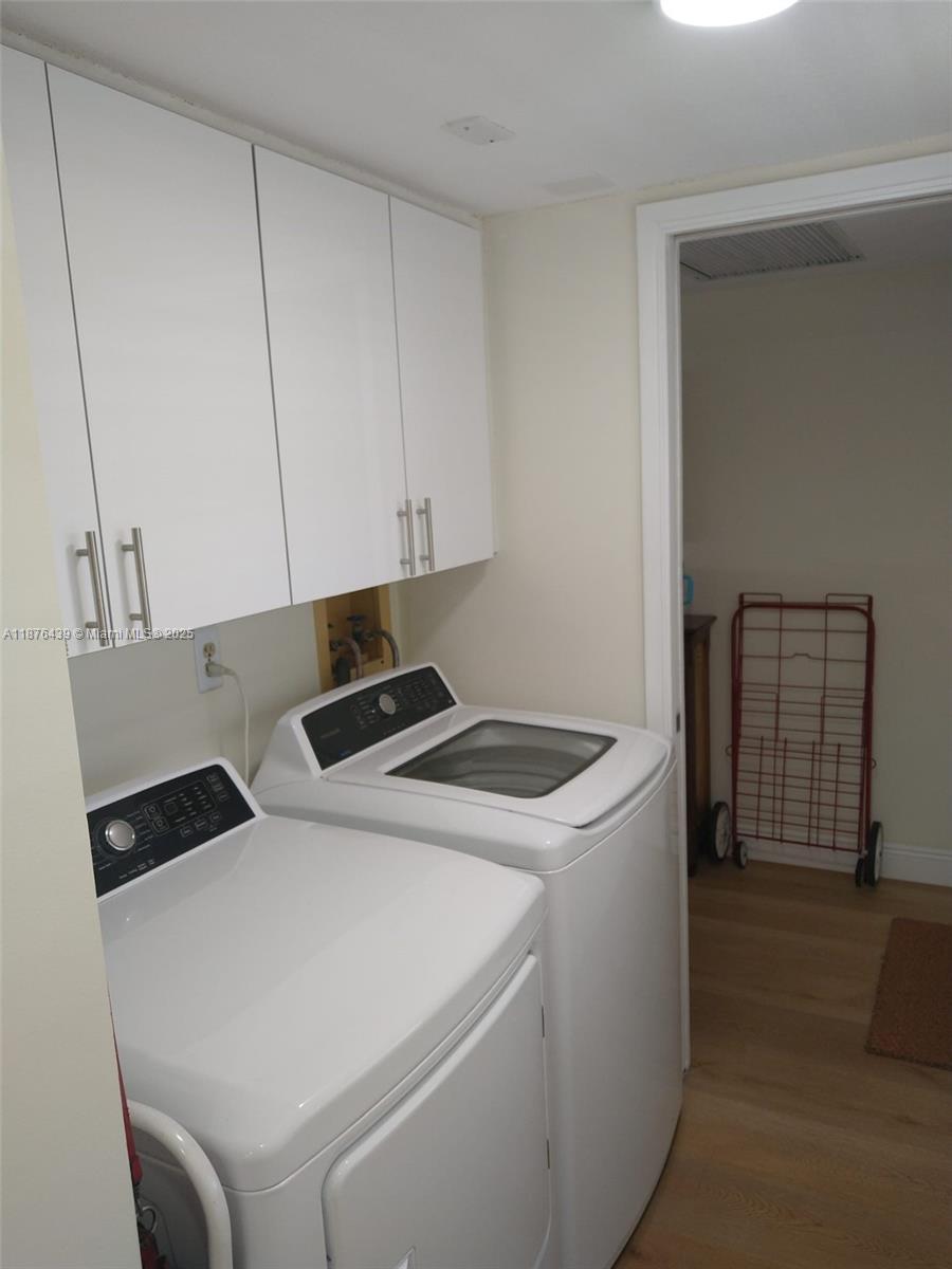3510 Oaks Way, Unit 509 Pompano Beach, FL 33069 - Photo 31 of 36 a utility room with dryer and washer