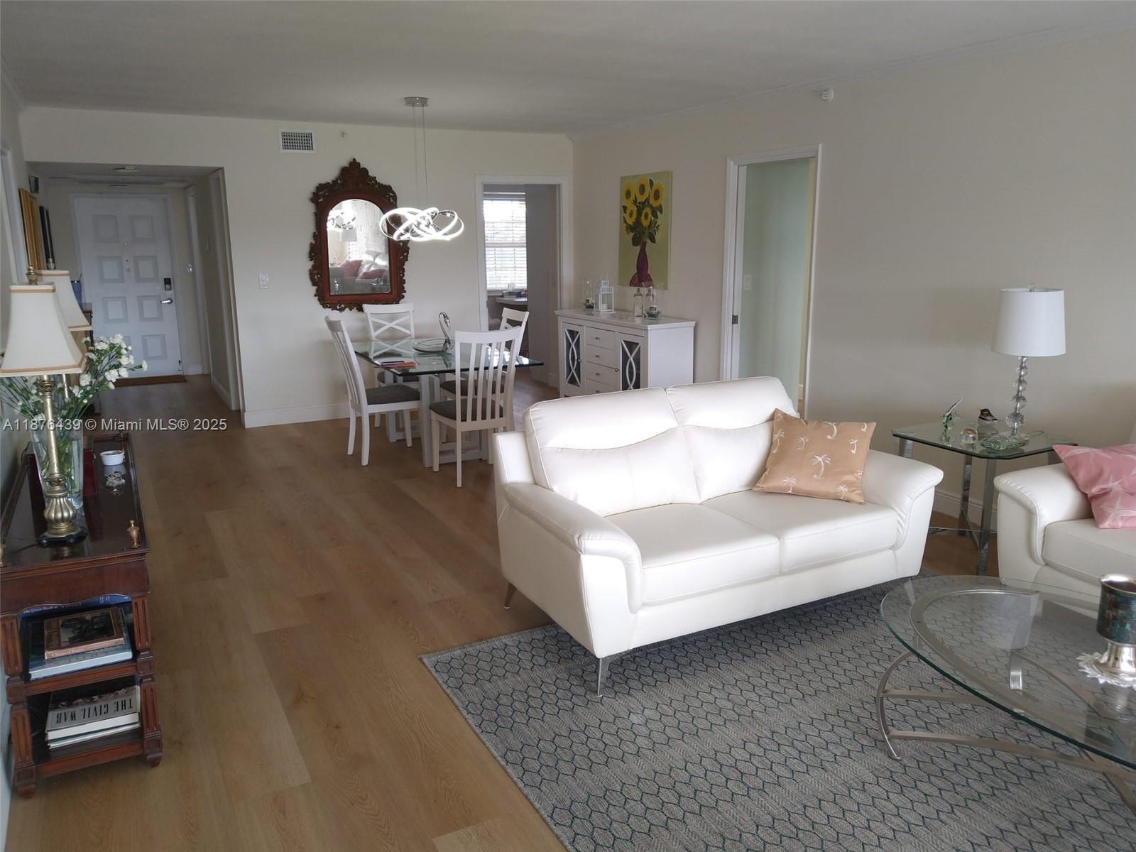 3510 Oaks Way, Unit 509 Pompano Beach, FL 33069 - Photo 36 of 36 a living room with furniture a dining table and chairs