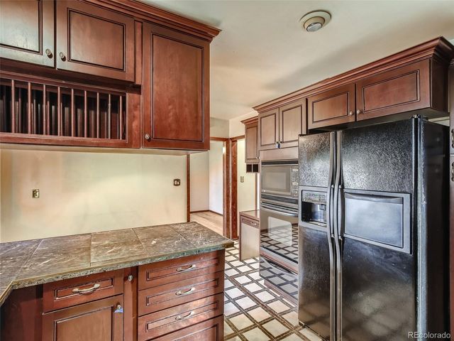 a kitchen with granite countertop stainless steel appliances and wooden cabinets