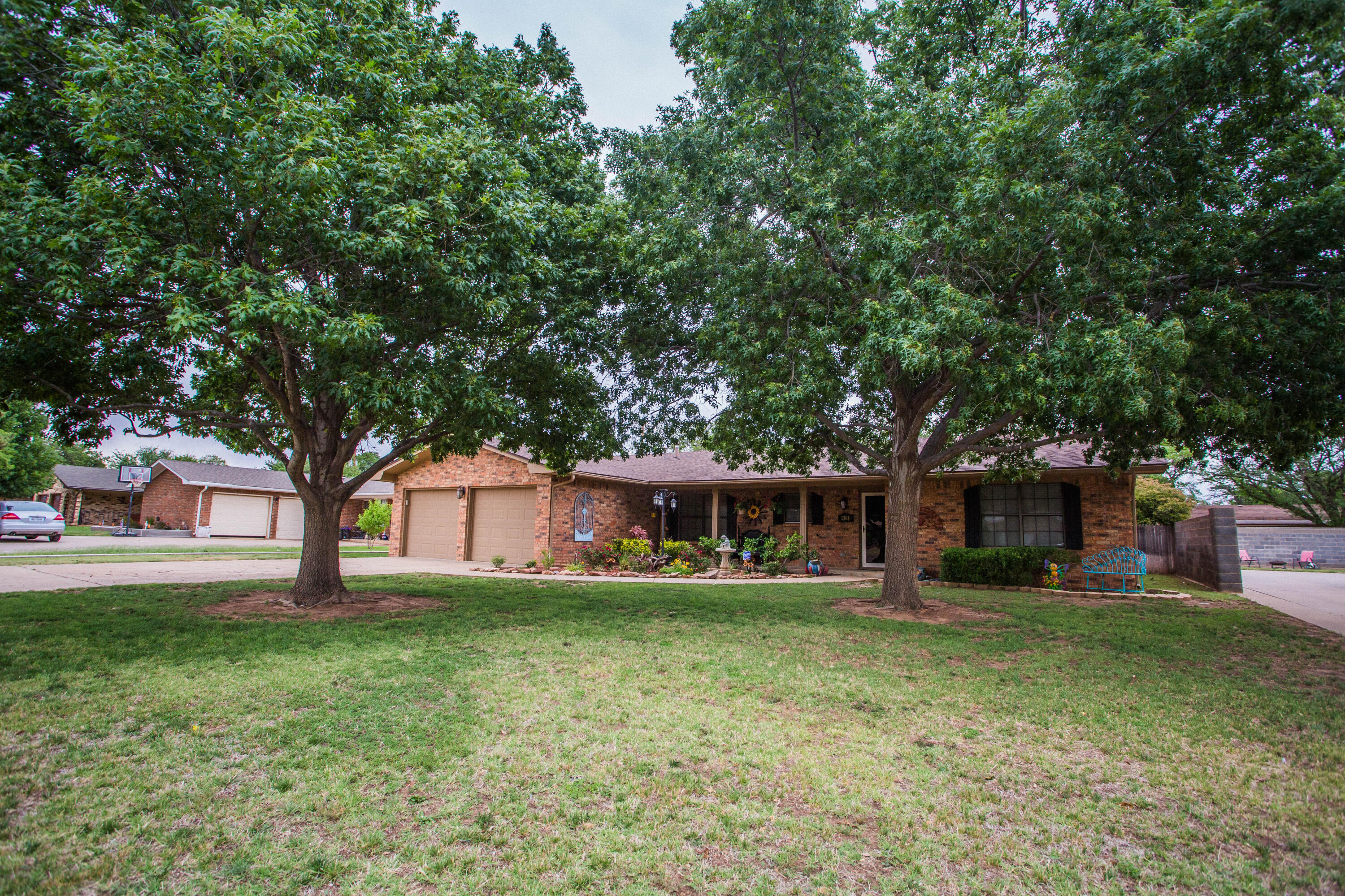 1304 Jefferson Drive Plainview, TX 79072 - Photo 2 of 50 a view of a house with a yard and large trees