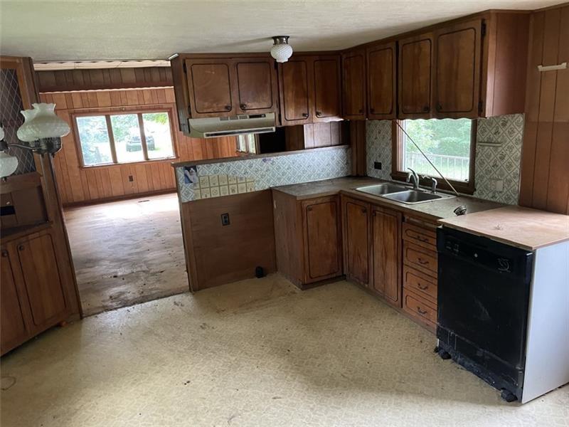 167 Vanderbilt Road Dickerson Run, PA 15430 - Photo 5 of 15 a kitchen with stainless steel appliances granite countertop a stove a sink and a microwave