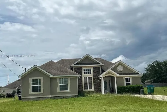 a front view of a house with a garden