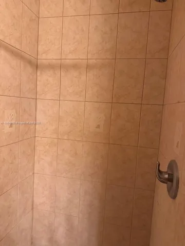 a view of a yard with wooden fence