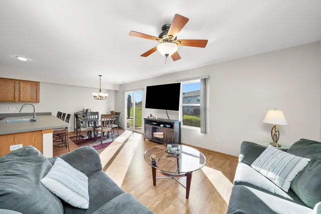 a living room with furniture and a flat screen tv with wooden floor