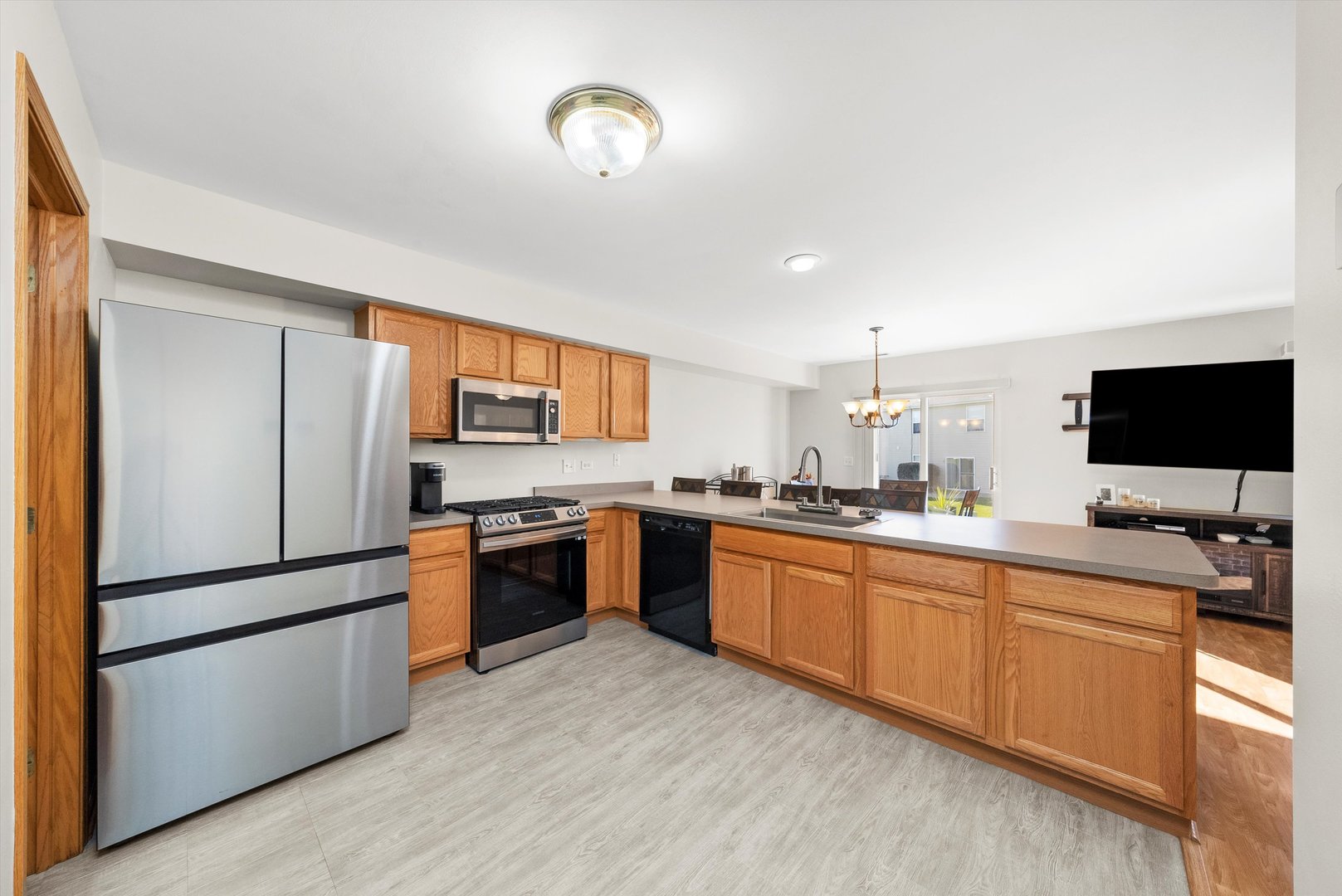 25236 Faraday Road Manhattan, IL 60442 - Photo 8 of 20 a kitchen with stainless steel appliances granite countertop a refrigerator a stove a sink and a microwave