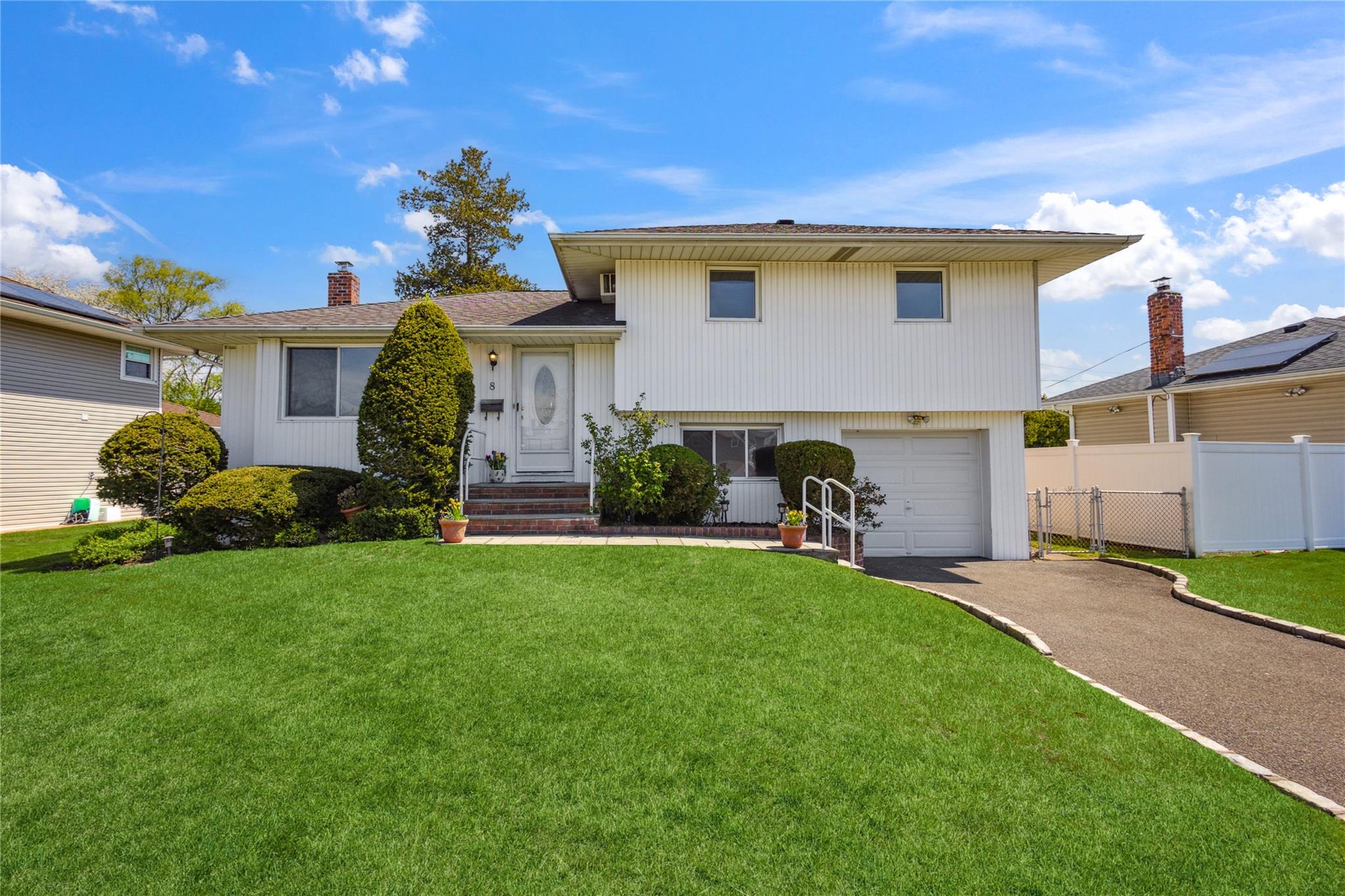 a front view of a house with a garden