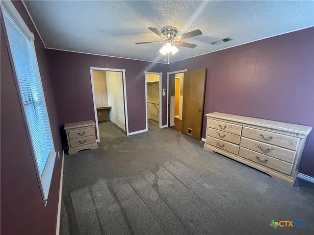 a view of a house with backyard and trees