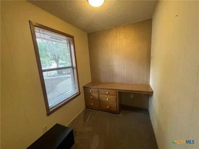 a view of a backyard with large trees
