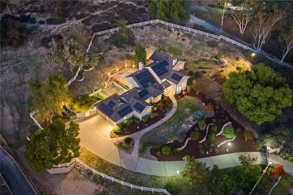 an aerial view of a house with a yard basket ball court and outdoor seating