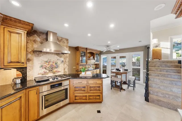 a kitchen with a white stove top oven and cabinets