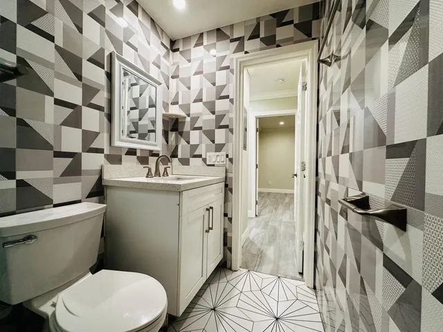 a bathroom with a sink toilet and shower