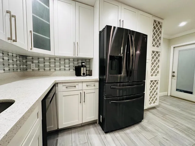 a kitchen with a sink stainless steel appliances and cabinets