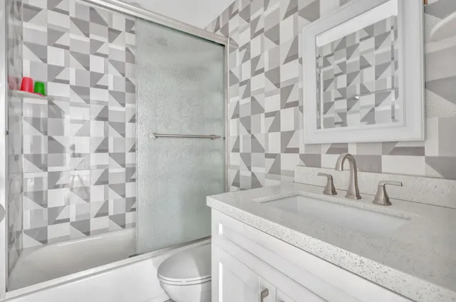 a bathroom with a sink toilet and shower