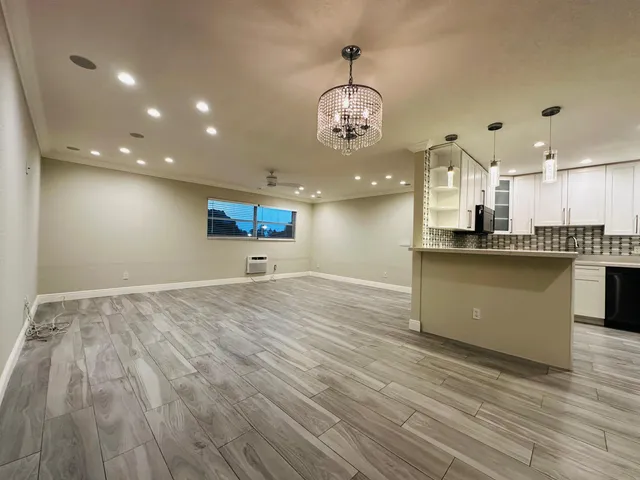 a view of a kitchen with a sink stainless steel appliances and cabinets