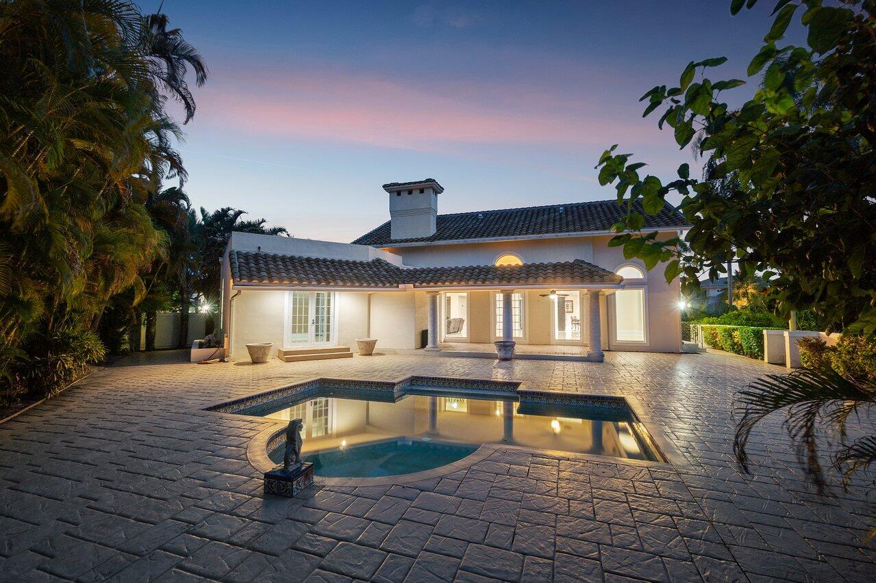 217 Thatch Palm Drive Boca Raton, FL 33432 - Photo 34 of 51 Twilight Back Yard & Pool Area