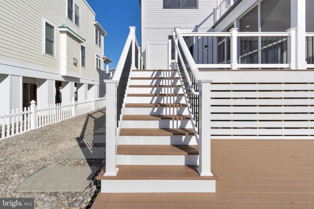 a view of an empty room with a window and fireplace