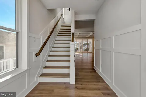 a view of a kitchen with wooden floor and a kitchen