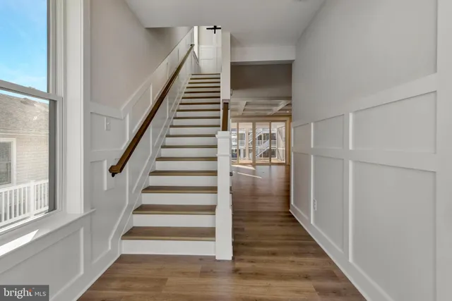 a view of a kitchen with wooden floor and a kitchen
