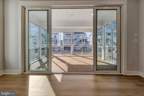 a kitchen with stainless steel appliances granite countertop a stove a sink and a refrigerator with white cabinets