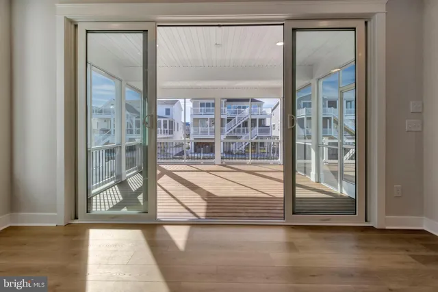 a kitchen with stainless steel appliances granite countertop a stove a sink and a refrigerator with white cabinets