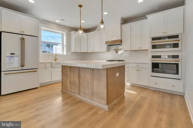 a view of a hallway with wooden floor and a cabinet