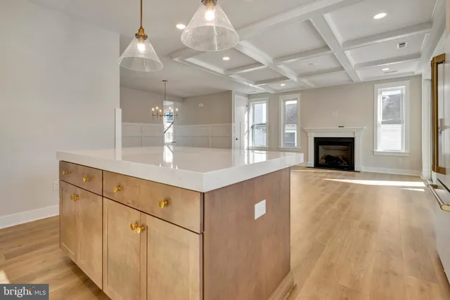 a kitchen with a sink cabinets and wooden floor