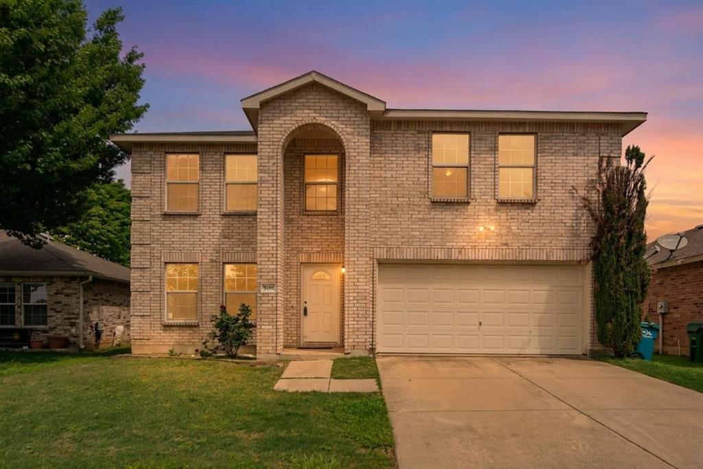 5718 Green Ivy Road Denton, TX 76210 - Photo 1 of 37 Two-story brick facade residence featuring an arched entryway, an attached two-car garage, multiple windows, and a concrete driveway
