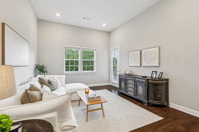 a living room with furniture a window and a table