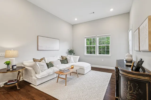 a bedroom with a bed and large windows