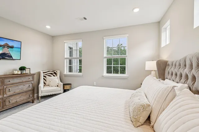 a bedroom with a large bed and dresser