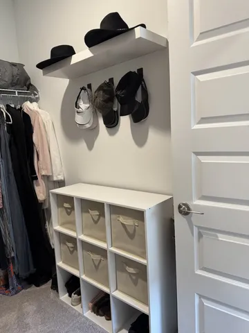 a view of walk in closet with clothes and shoes