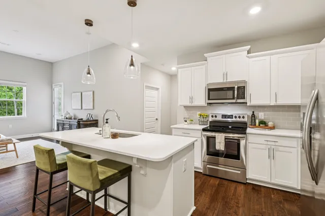 a kitchen with a stove a sink and a refrigerator