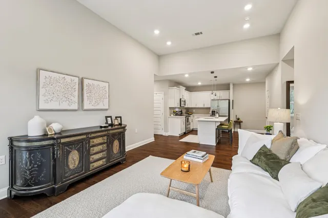 a living room with furniture and kitchen view